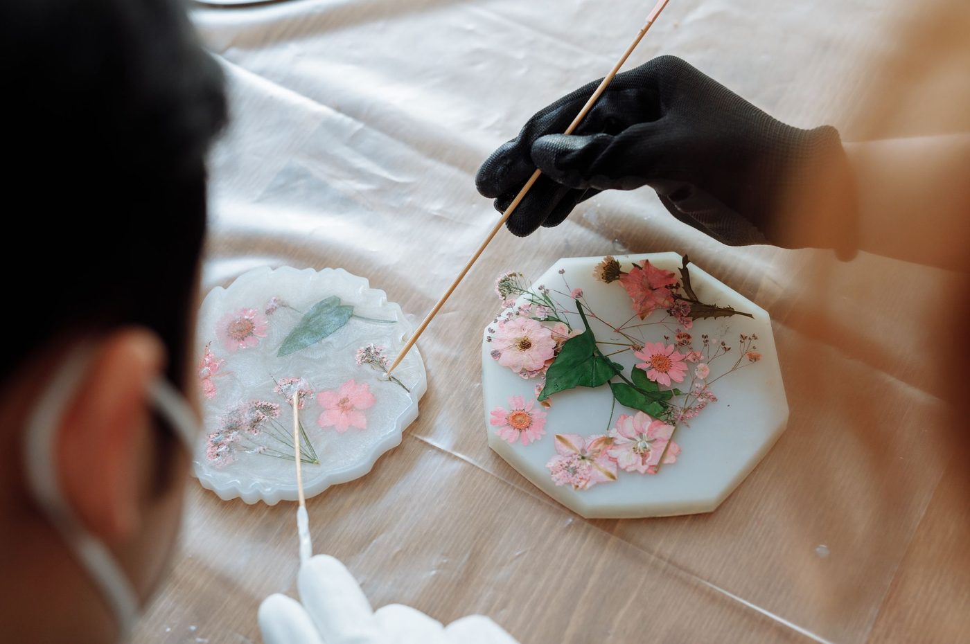 Flowers being arranged in resin moulds with a fine tool